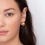 double link gold stud earrings close up detail