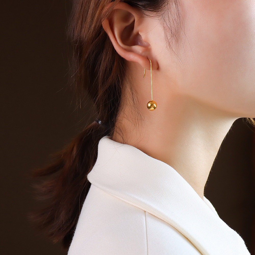 long teardrop earrings gold styling lifestyle shot