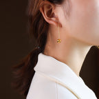 long teardrop earrings gold styling lifestyle shot