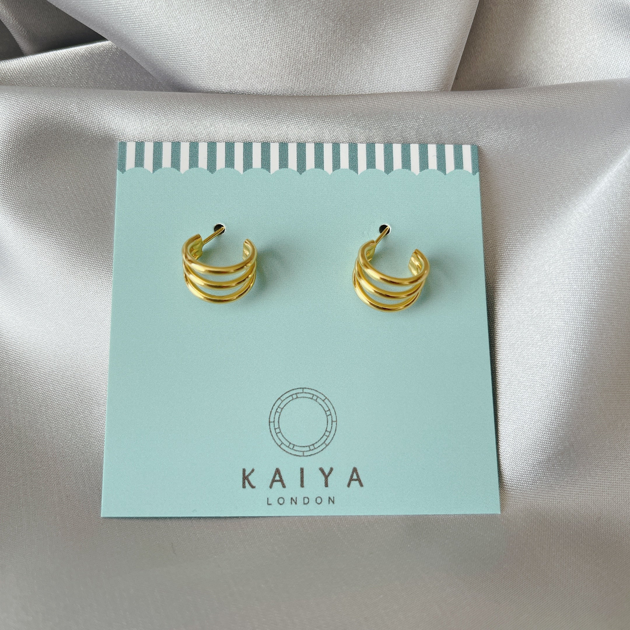 triple dot climber earrings close up three gold dots