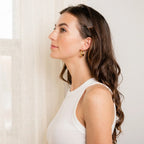 open oval gold hoop earrings close up minimalist design