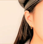 gold and silver oval stud earrings styling shot
