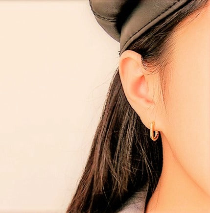 gold and silver oval stud earrings styling shot