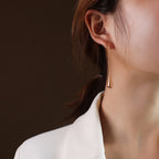 long teardrop drop earrings worn on model ear