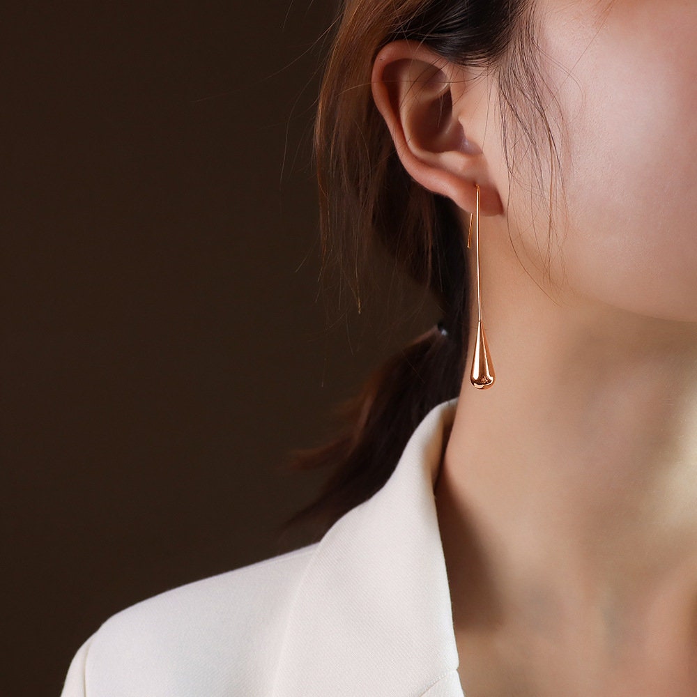 long teardrop drop earrings worn on model ear