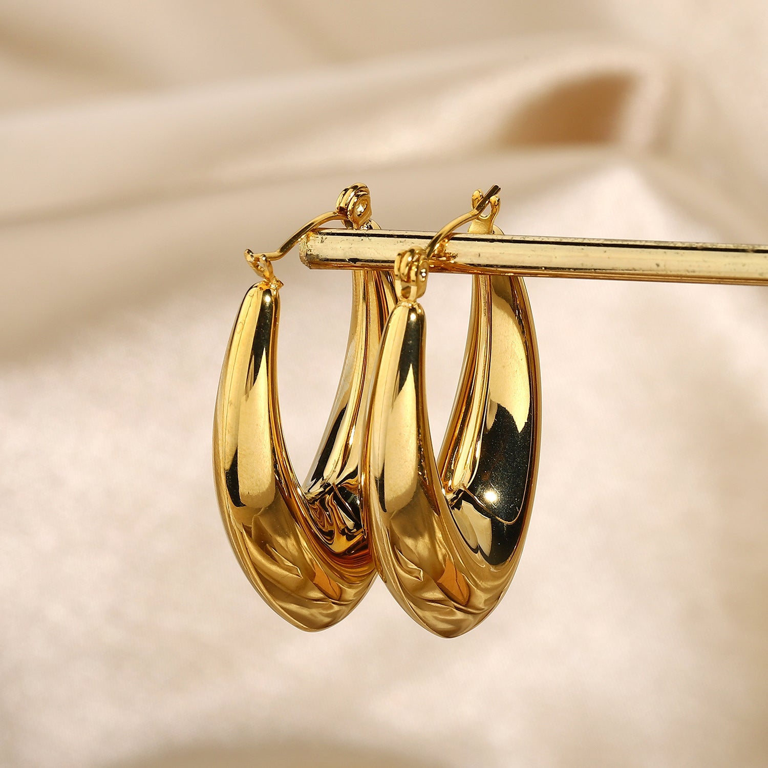 sculptural gold oval hoops styling shot PVD coated