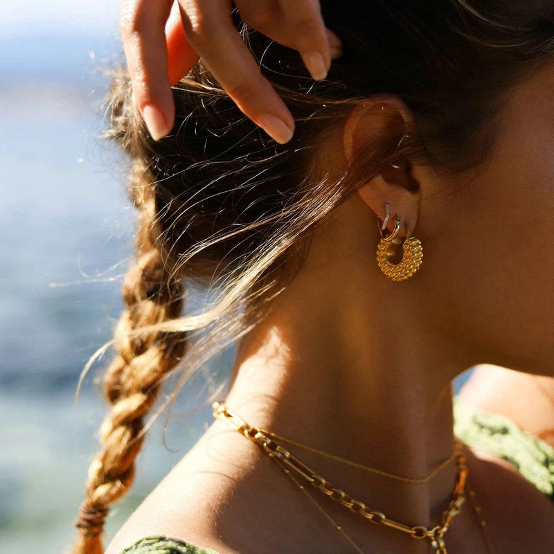 large textured gold hoop earrings close up edge detail