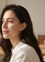 model wearing dainty tear drop gold pvd medical grad stud earrings