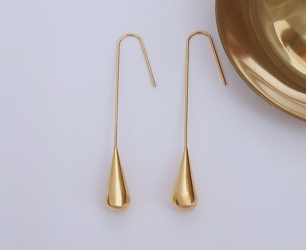 rose gold long teardrop drop earrings on model