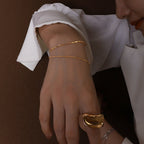 gold snake chain bracelet on model wrist