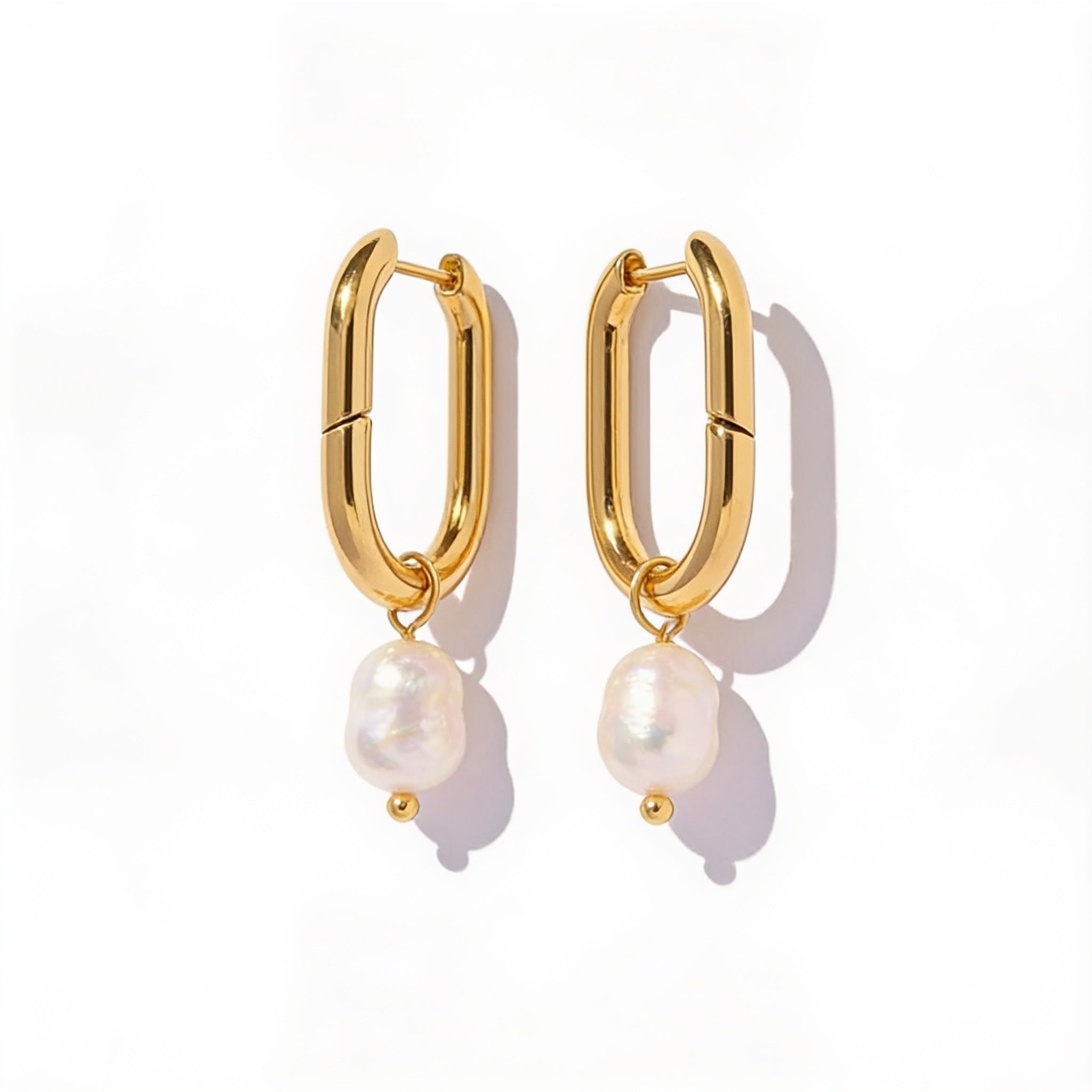 oval gold pearl hoop earrings side view on model