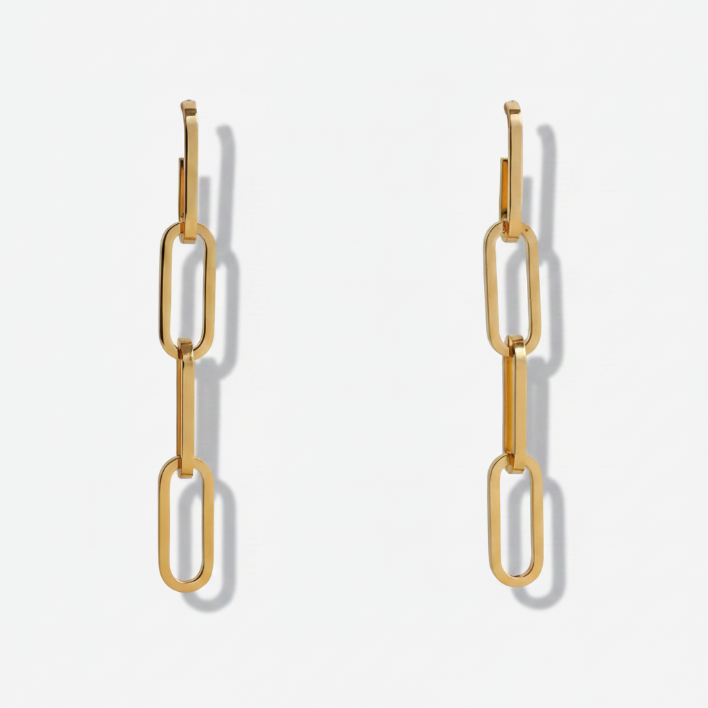 Gold chain-style earrings on a light gray background